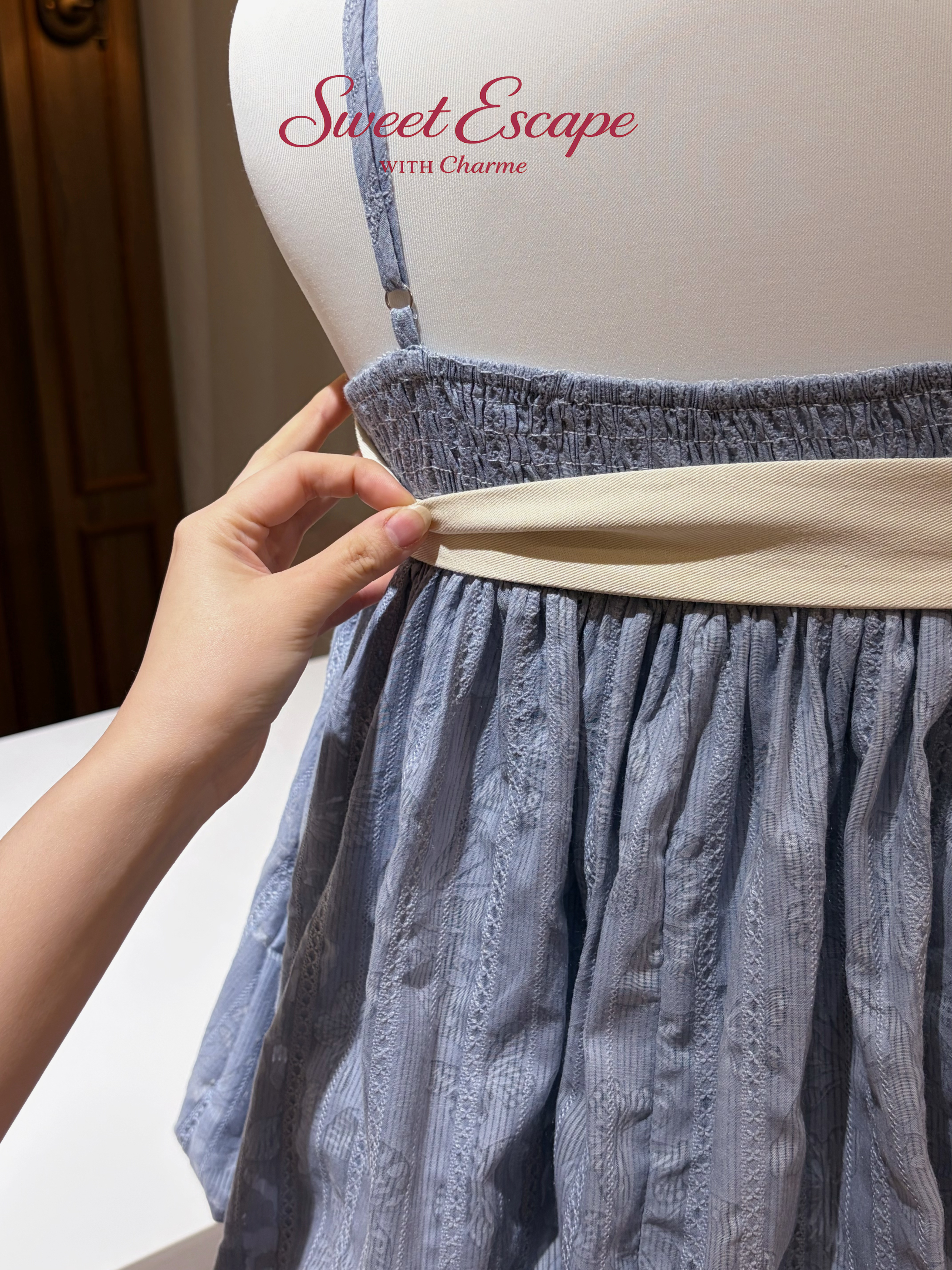 Close-up detail of textured cami top with buckle accent and matching shorts set