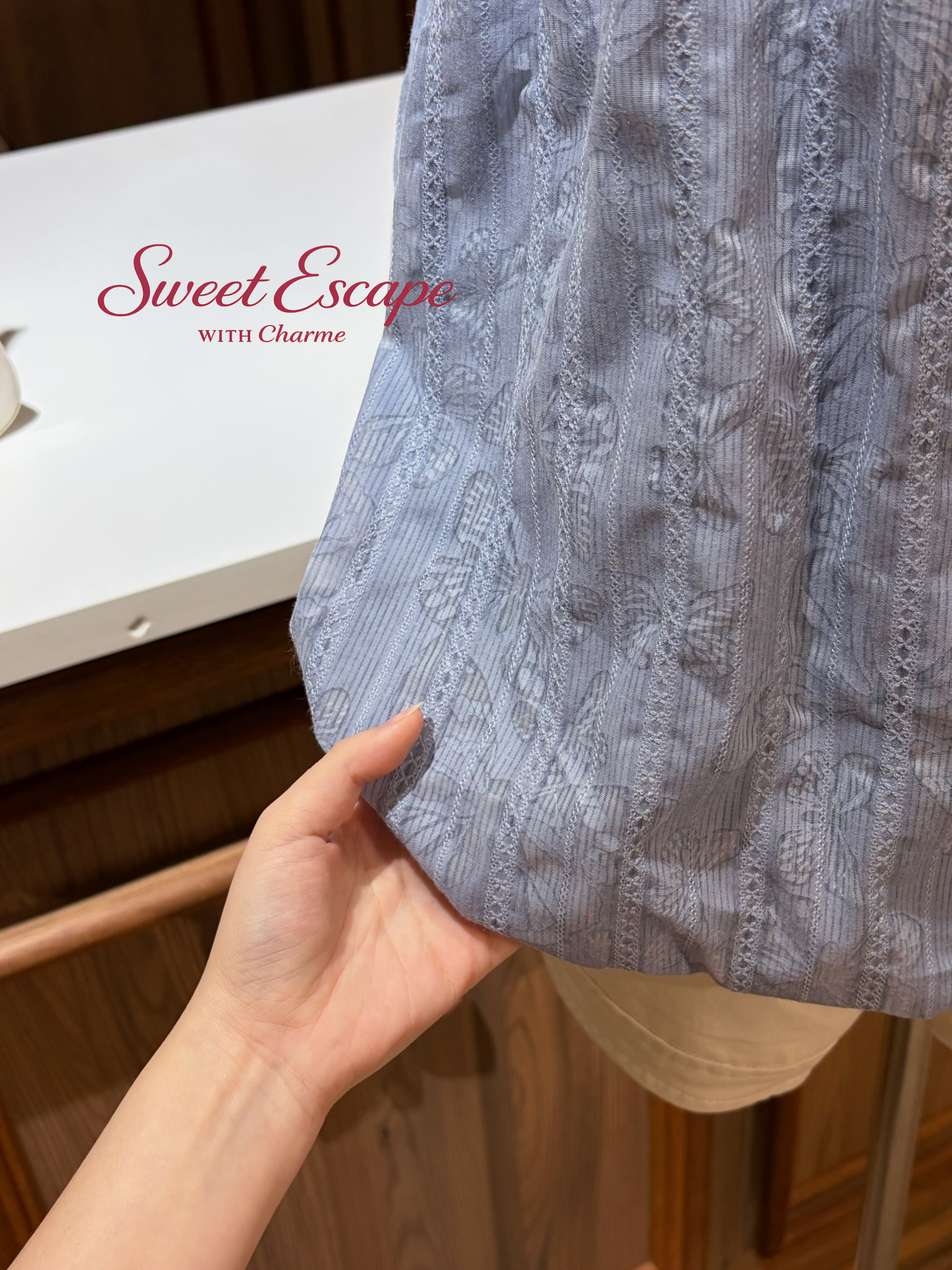 Close-up of a textured fabric held by a hand with 'Sweet Escape' branding in the background.