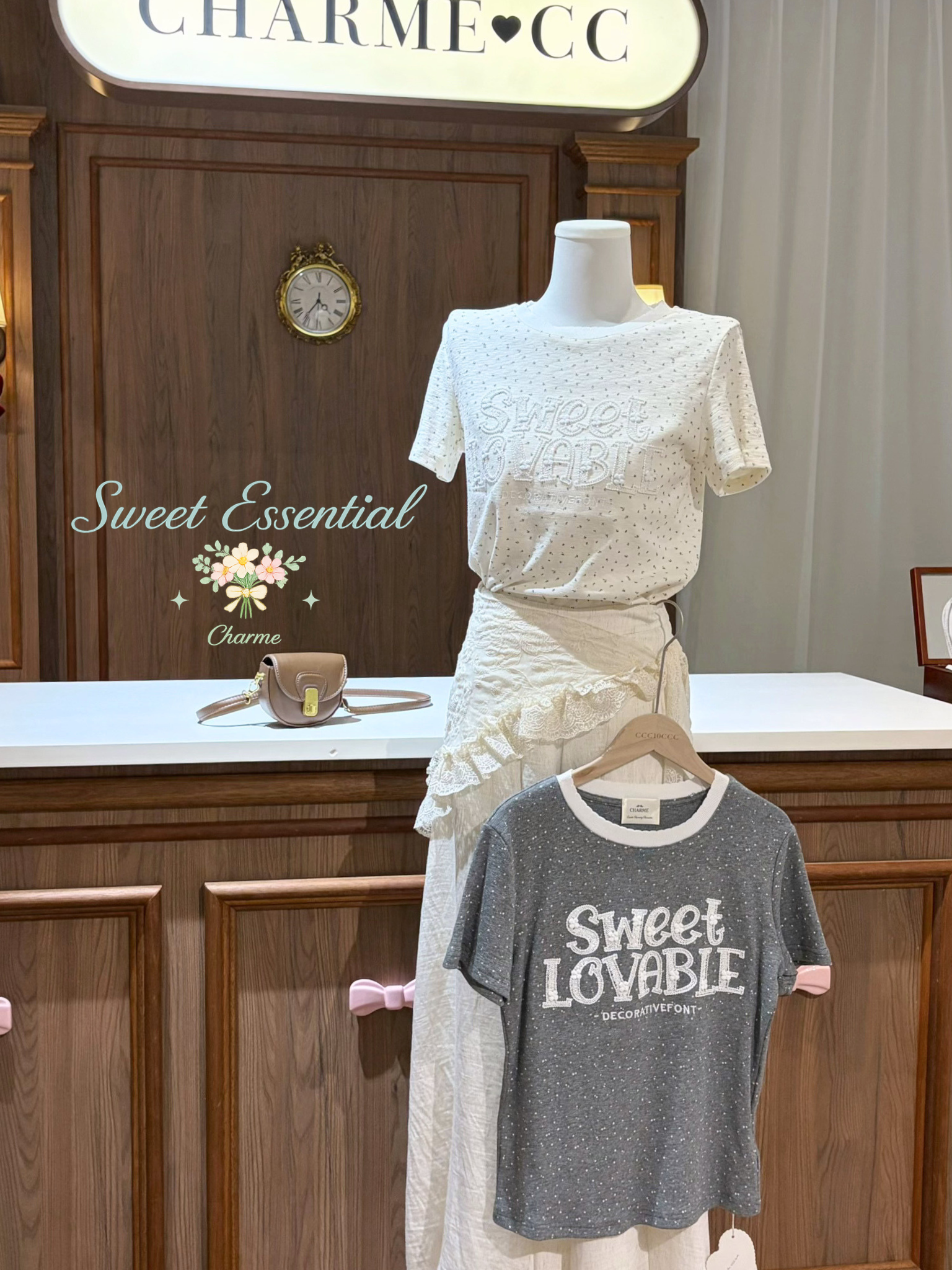 Mannequin wearing a white dress with a gray t-shirt labeled 'Sweet Lovable' in a store setting.