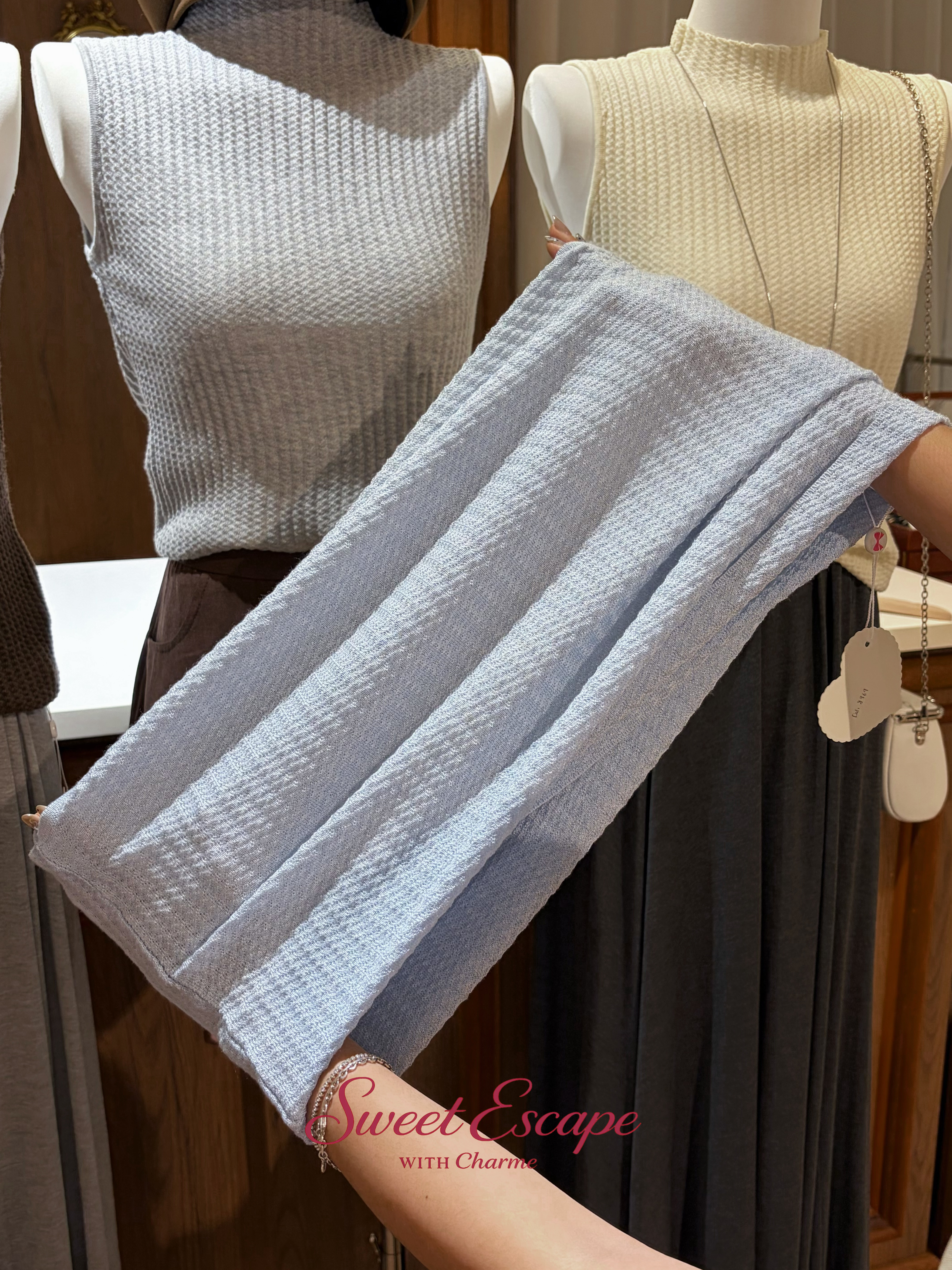 Close-up detail of textured knit sleeveless top with soft stretch fabric
