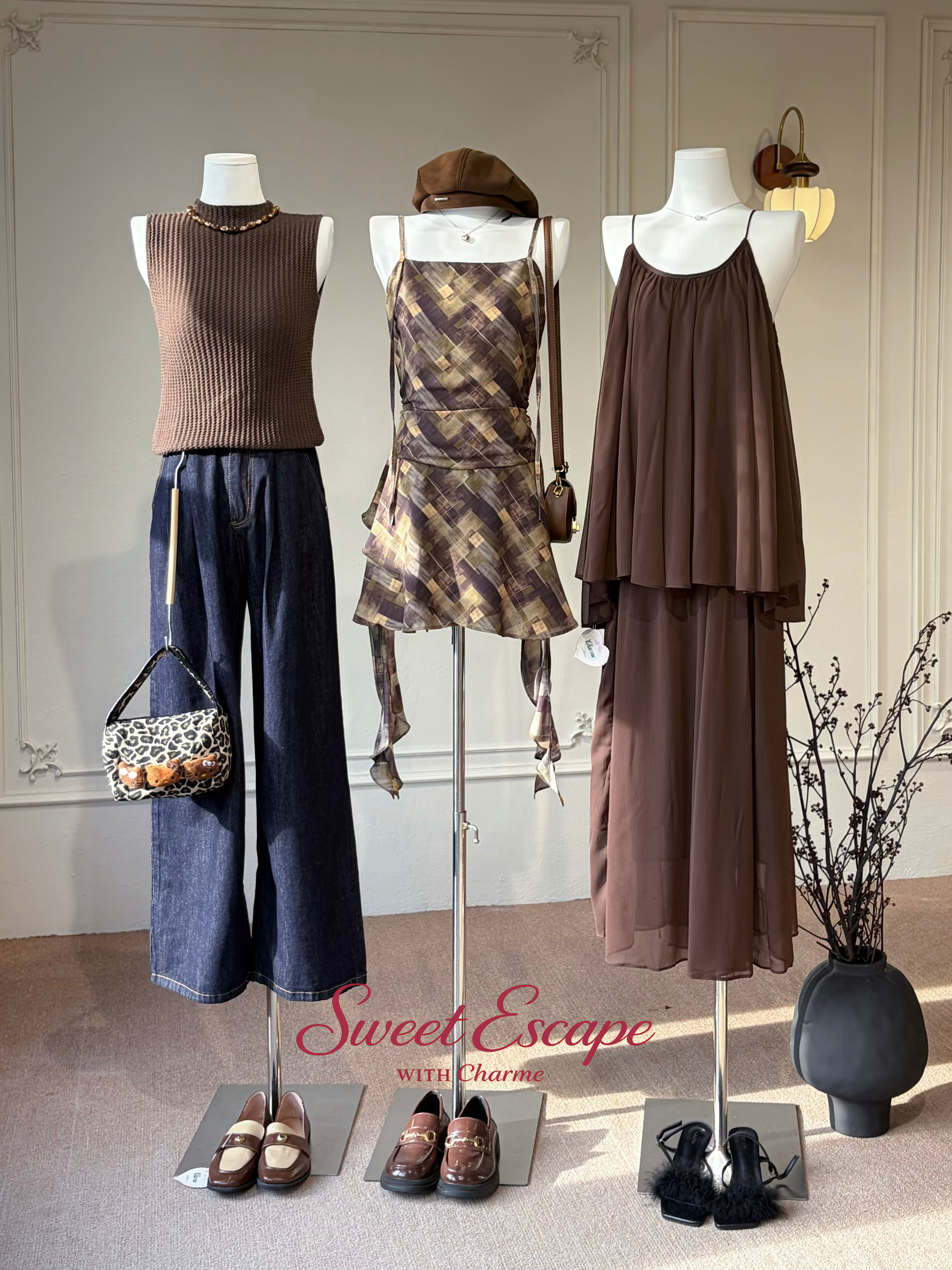 Mannequins dressed in brown and plaid outfits with accessories on a neutral background, featuring 'Sweet Escape with Charm' branding.