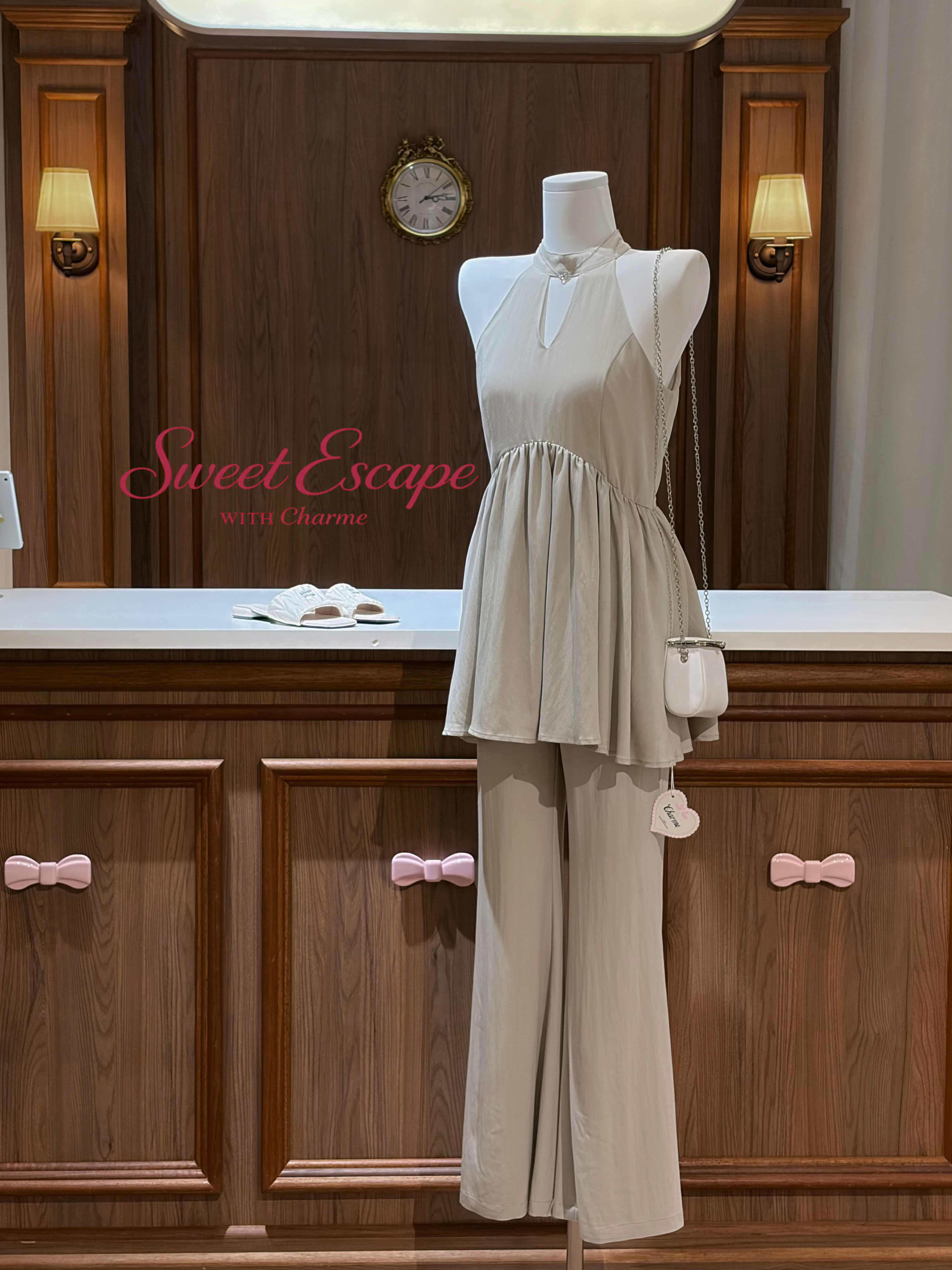 Mannequin wearing a beige outfit with a handbag in a bathroom setting, featuring 'Sweet Escape with Charme' text.